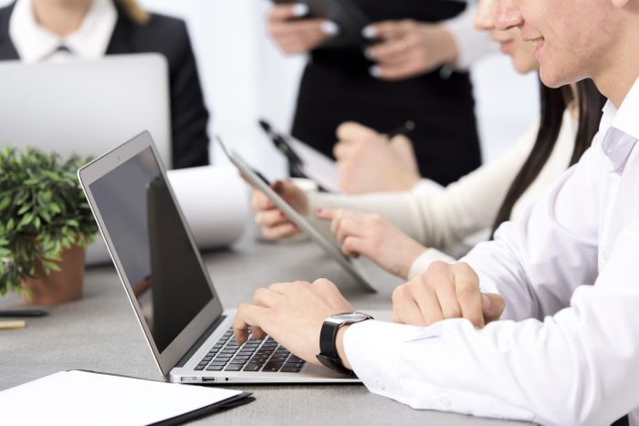 Smiling Businessman S Hand Using Laptop Sitting With His Colleague Desk