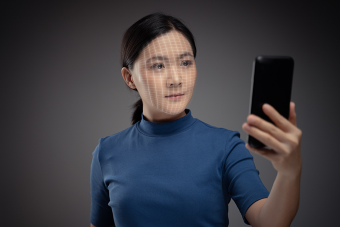 Asian Woman Scans Face By Smart Phone Using Facial Recognition System 1718050092