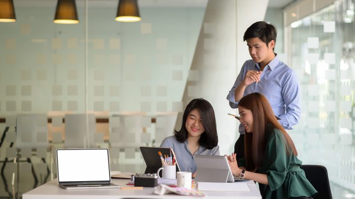 Business Colleagues Discussing Laptop Table Office 1737537020