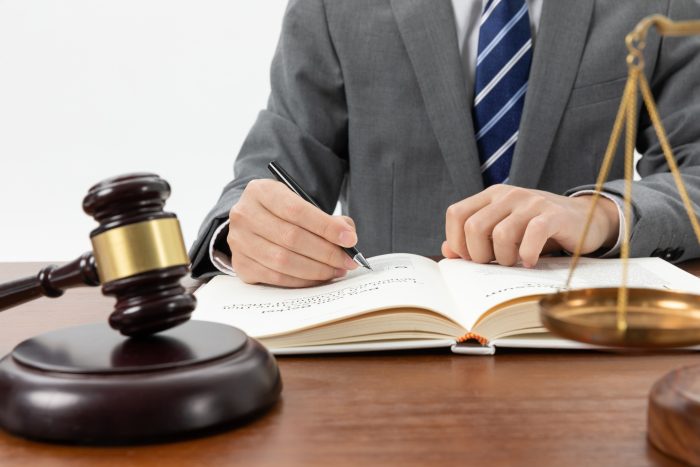 Closeup Shot Person Writing Book With Gavel Table Fpt Is