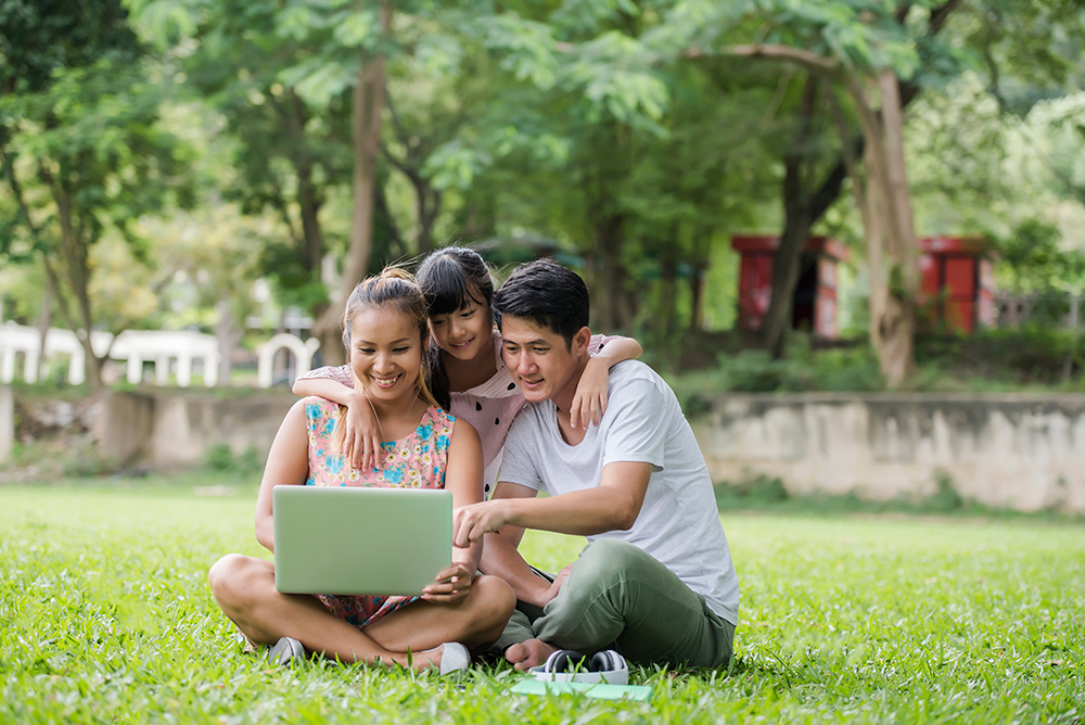 Happy Family Father Mother Daughter Sitting Grass Playing Laptop Outdoor Park 1719318098