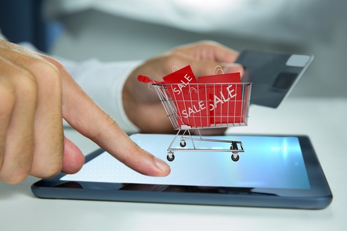 Composite Image Of Hand Using Tablet Computer For Buy With The Credit Card